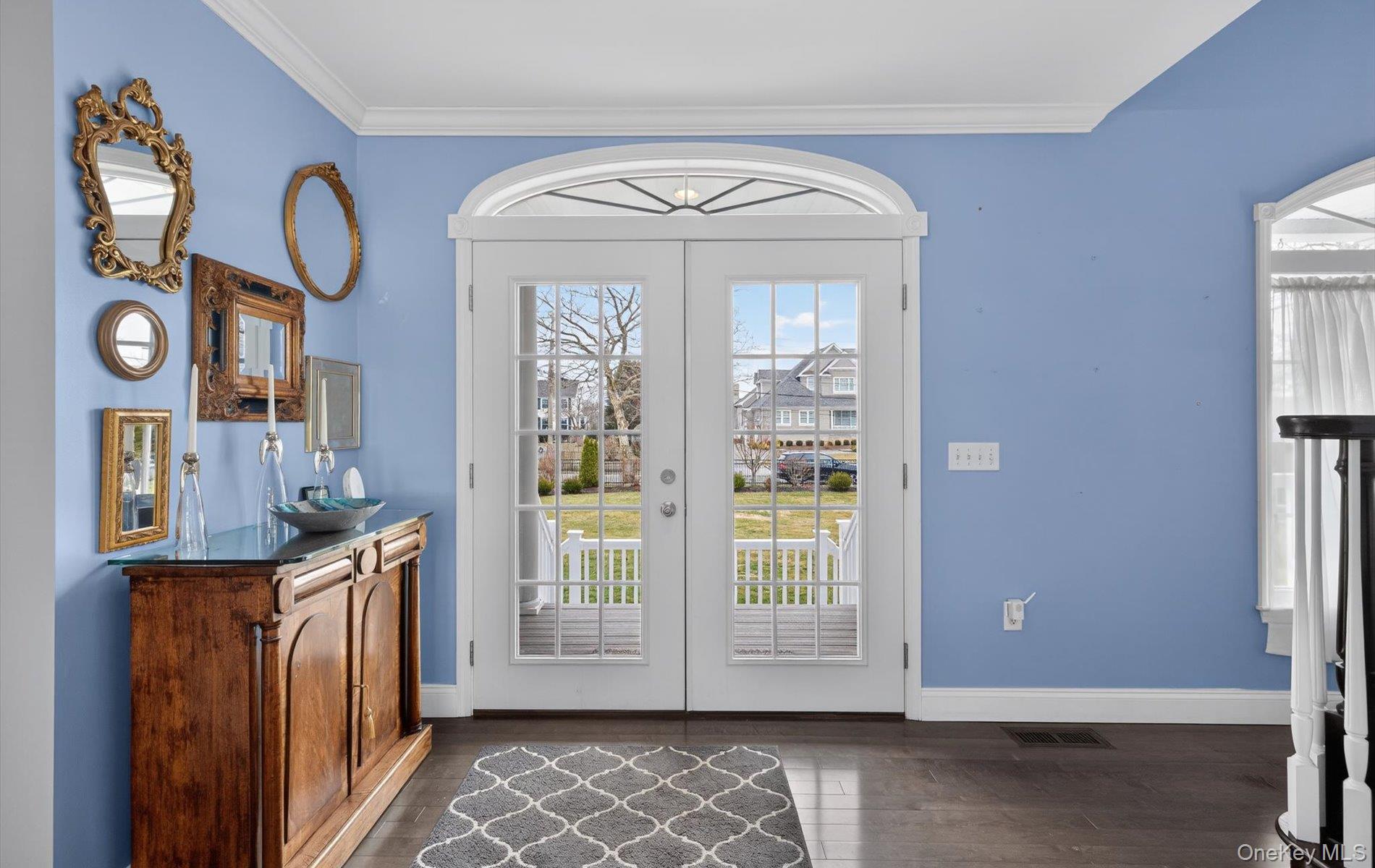 108 Awixa Avenue Bay Shore, NY 11706 - Photo 3 of 47 Doorway featuring ornamental molding, wood finished floors, and french doors