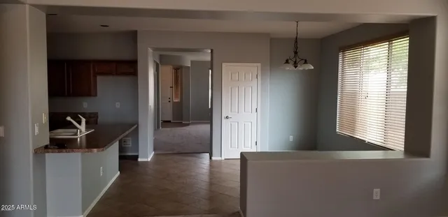 a view of hallway with furniture and a large window