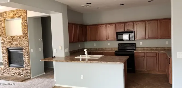 a kitchen with a stove a sink and a microwave