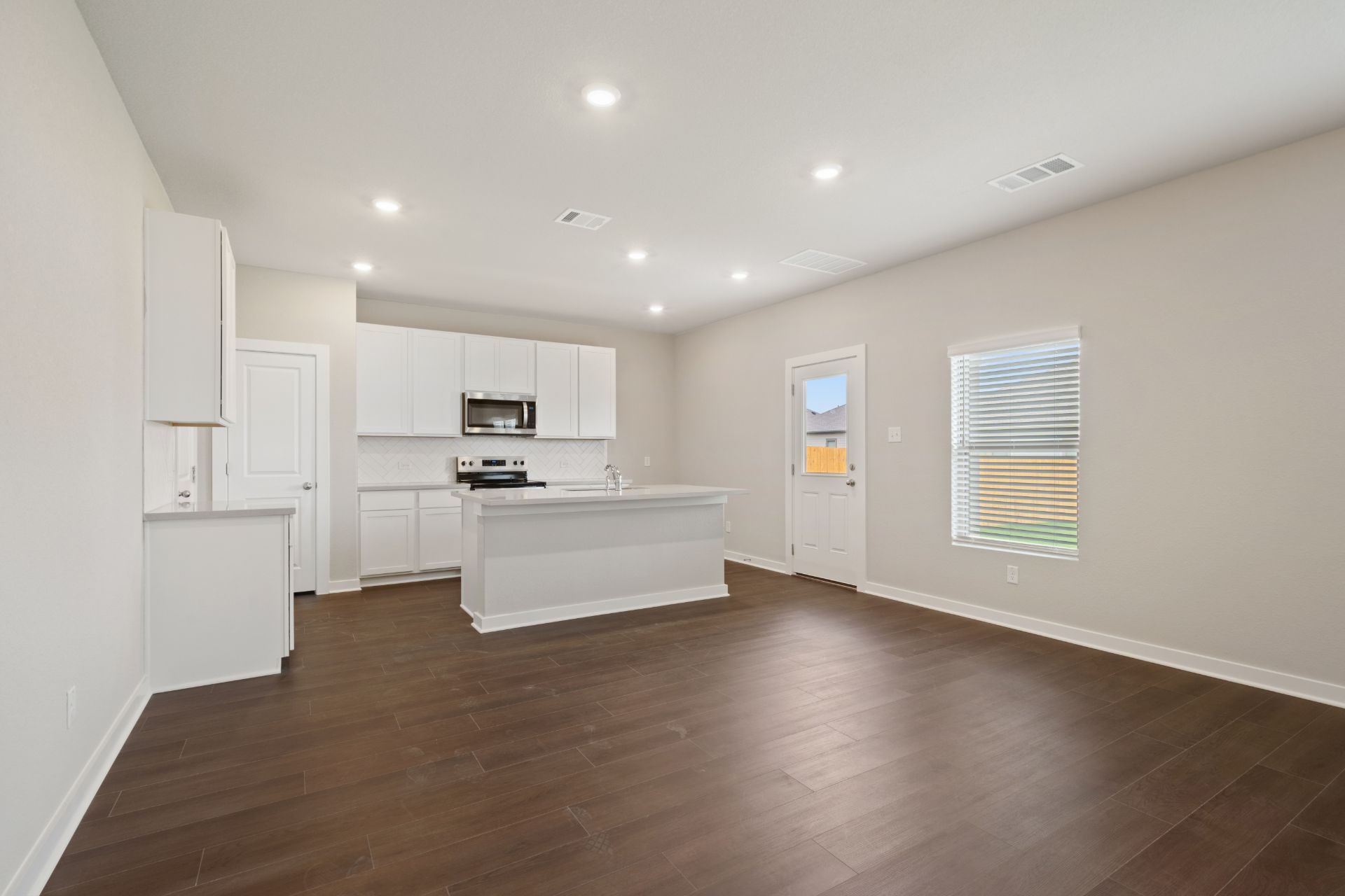 13801 Ryan Range Lane Elgin, TX 78621 - Photo 7 of 28 From Family Room to Open Concept Kitchen - Representative Photo