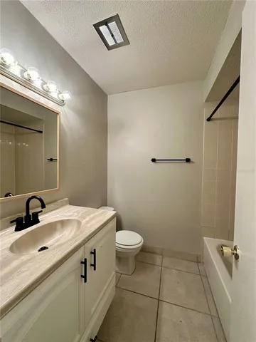 a bathroom with a sink a toilet a mirror and vanity