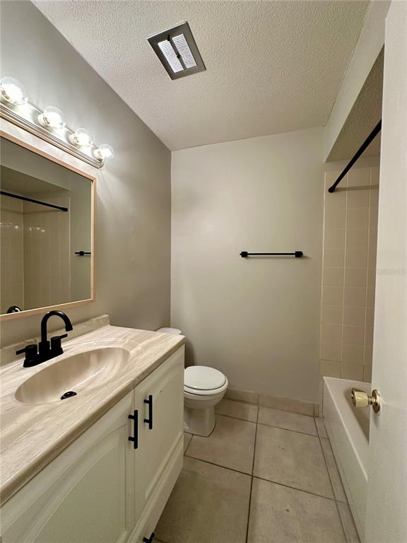1500 Gay Road, Unit 5 Winter Park, FL 32789 - Photo 11 of 17 a bathroom with a sink a toilet a mirror and vanity