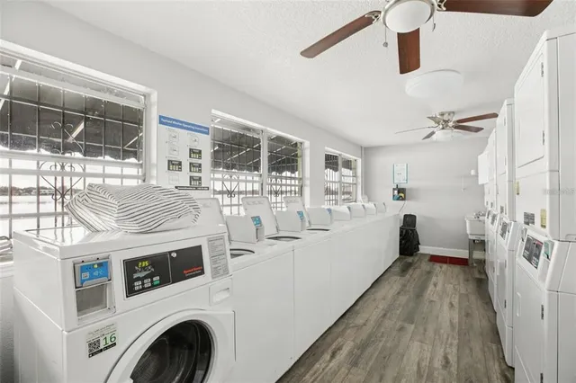a view of washer and dryer with kitchen in the background