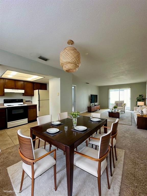 1500 Gay Road, Unit 5 Winter Park, FL 32789 - Photo 4 of 17 a living room with furniture and a chandelier