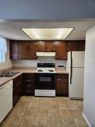 a kitchen with a refrigerator and a sink