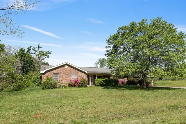 a front view of house with yard and trees