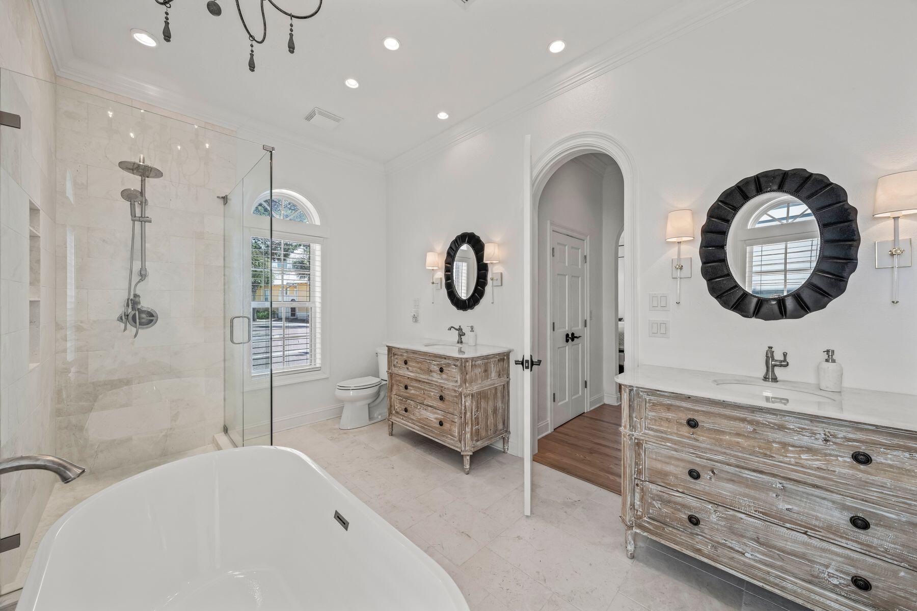 428 Beach Bike Way Seacrest, FL 32461 - Photo 11 of 32 a spacious bathroom with a double vanity sink a mirror a bathtub and a shower