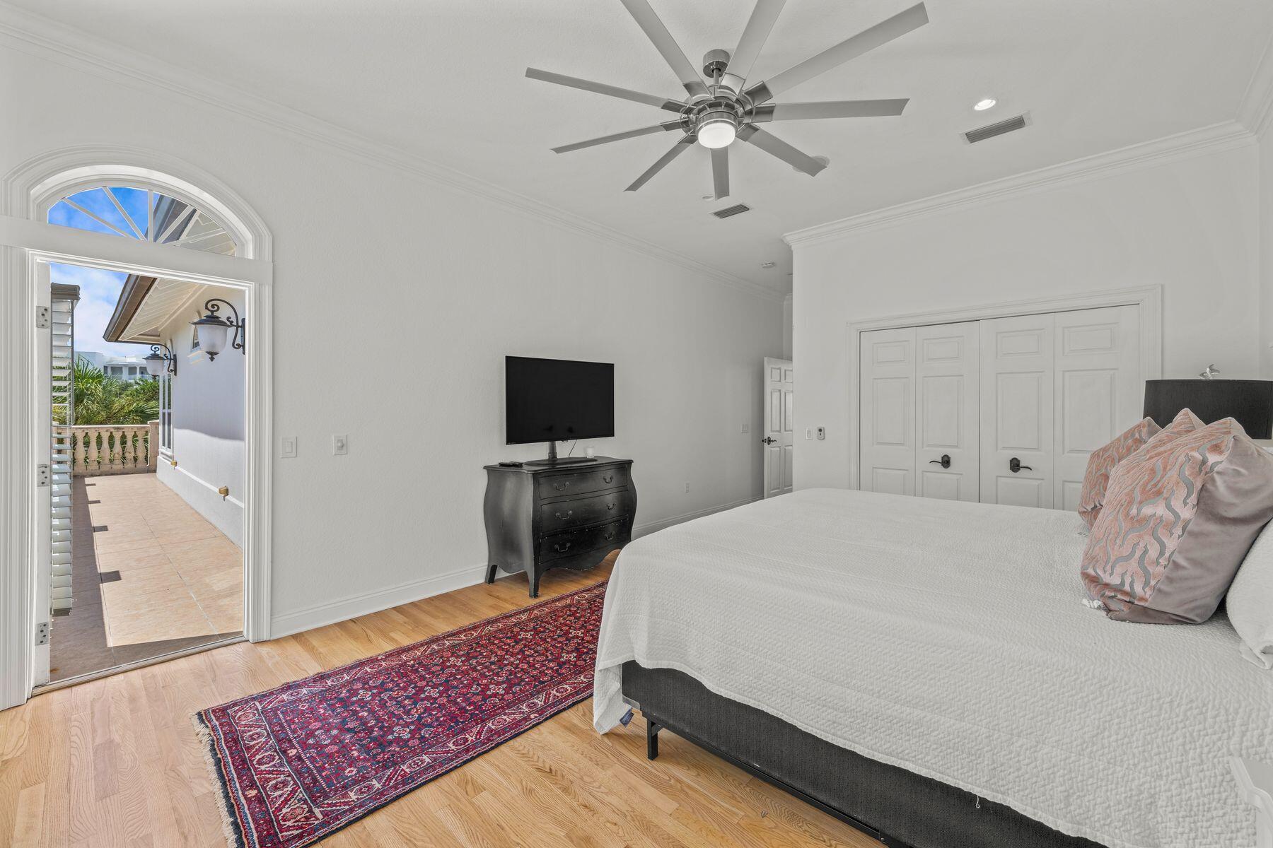 428 Beach Bike Way Seacrest, FL 32461 - Photo 19 of 32 a bedroom with a bed and a chandelier