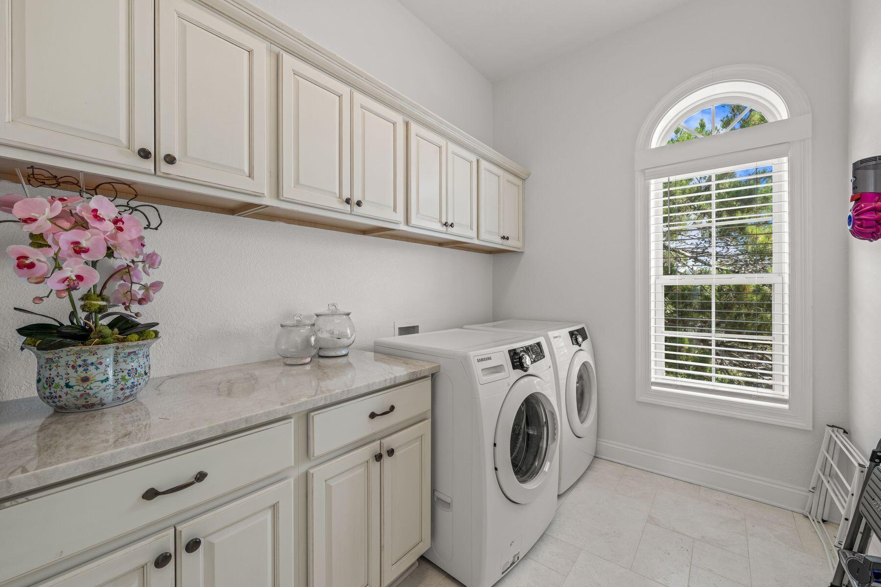 428 Beach Bike Way Seacrest, FL 32461 - Photo 21 of 32 a utility room with granite countertop cabinets washer and dryer