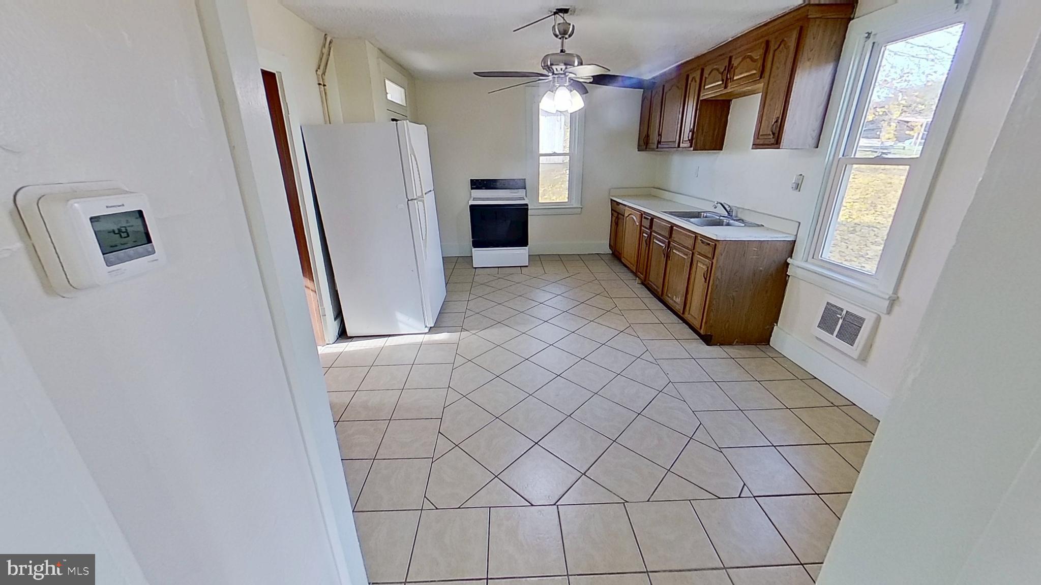 58 High Street Felton, PA 17322 - Photo 2 of 9 a kitchen with granite countertop white cabinets and refrigerator
