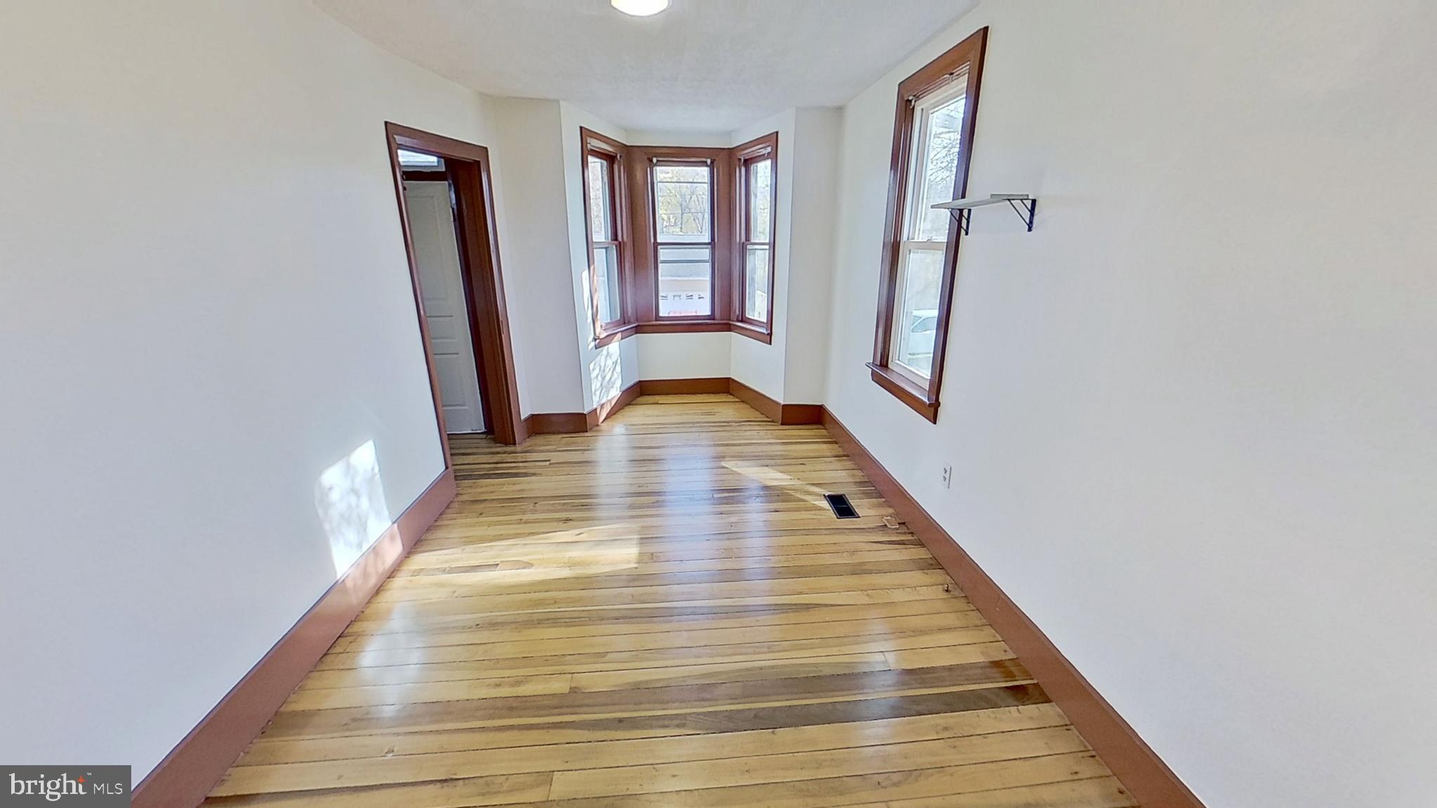 58 High Street Felton, PA 17322 - Photo 3 of 9 a view of a hallway with wooden floor and staircase