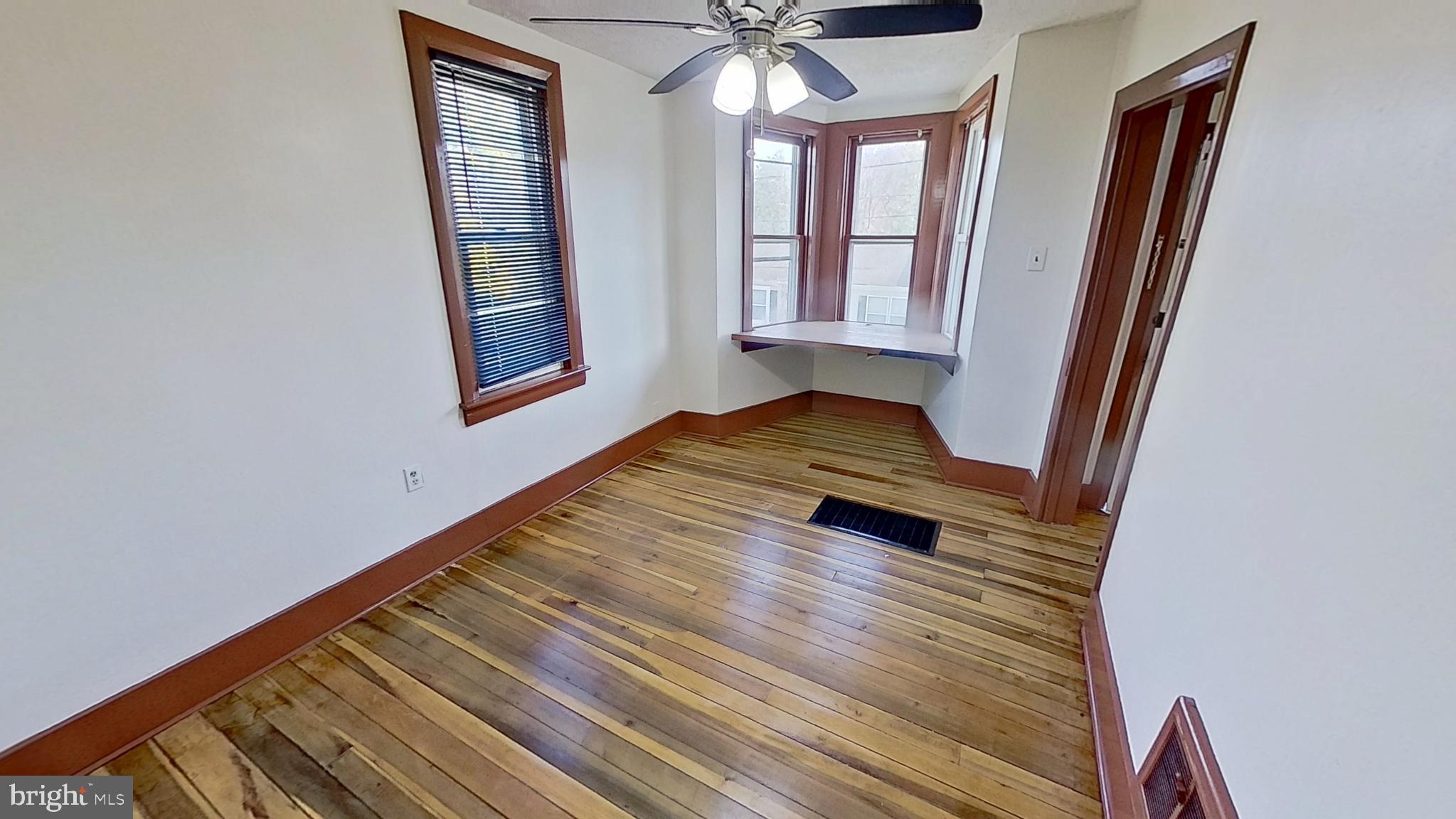 58 High Street Felton, PA 17322 - Photo 4 of 9 a view of an empty room with wooden floor and a window