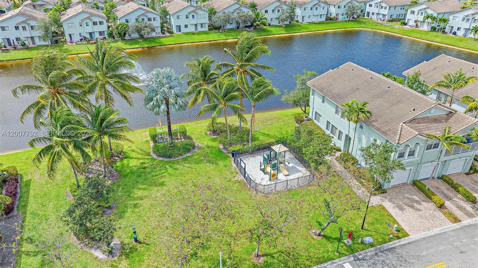 3229 Laurel Ridge Circle, Unit 3229 Riviera Beach, FL 33404 - Photo 22 of 24 a view of a swimming pool with a yard
