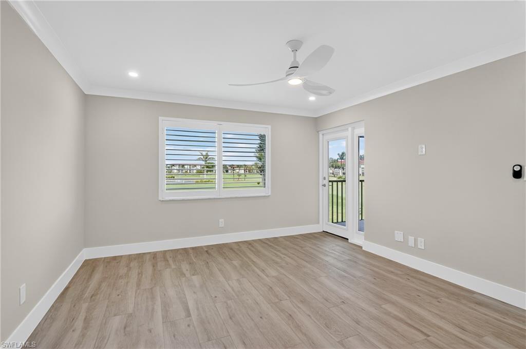 29 High Point Circle East, Unit 204 Naples, FL 34103 - Photo 13 of 29 wooden floor in an empty room with a window