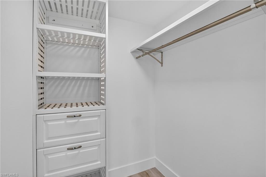 29 High Point Circle East, Unit 204 Naples, FL 34103 - Photo 16 of 29 a view of walk in closet with empty racks