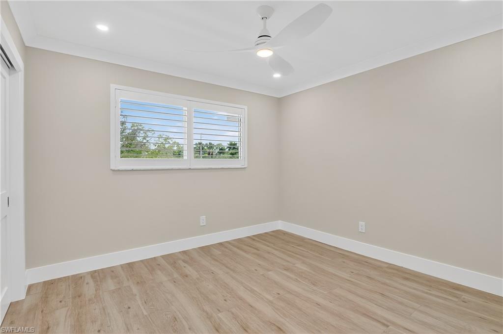 29 High Point Circle East, Unit 204 Naples, FL 34103 - Photo 17 of 29 wooden floor in an empty room with a window