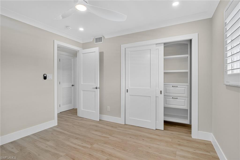 29 High Point Circle East, Unit 204 Naples, FL 34103 - Photo 19 of 29 an empty room with closet and a window