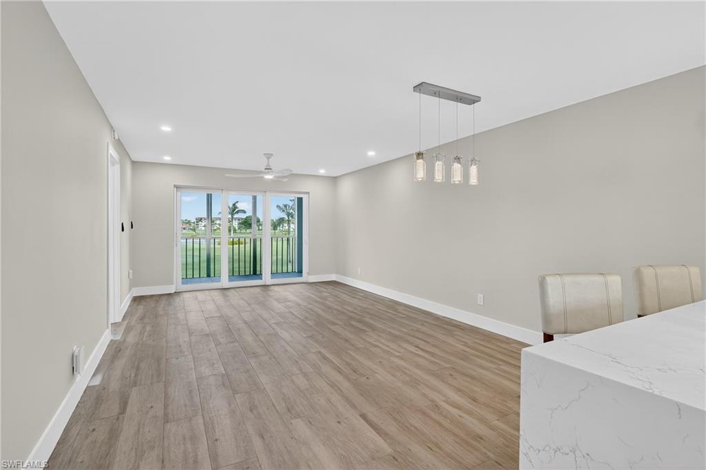 29 High Point Circle East, Unit 204 Naples, FL 34103 - Photo 9 of 29 a view of an empty room with wooden floor and a window
