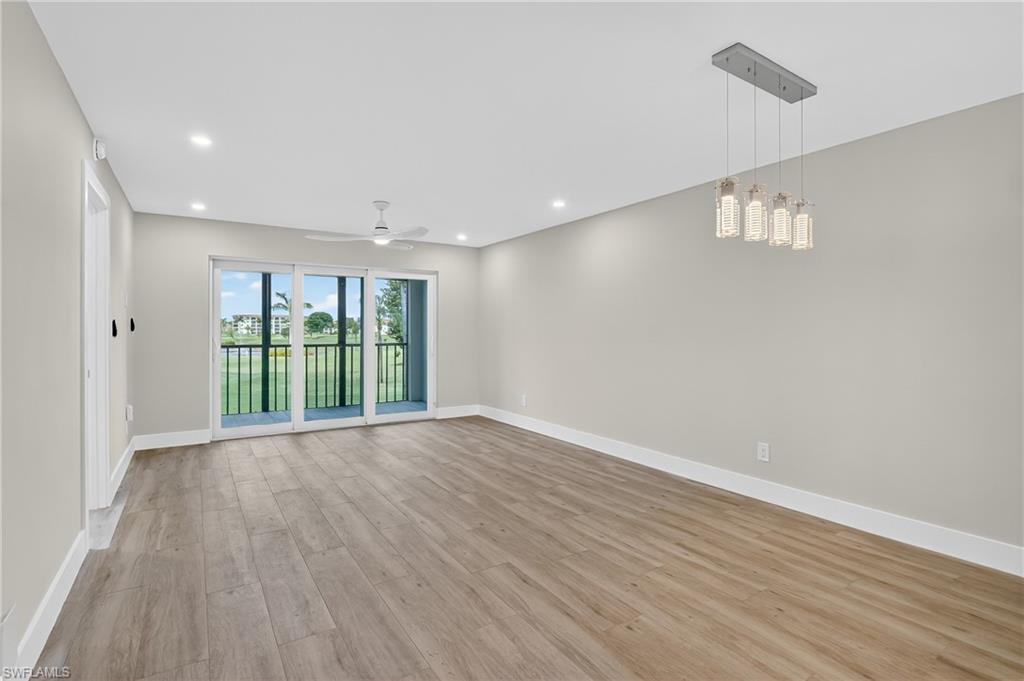 29 High Point Circle East, Unit 204 Naples, FL 34103 - Photo 10 of 29 a view of an empty room with wooden floor and a window