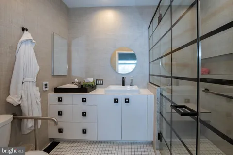 a bathroom with a sink mirror and vanity