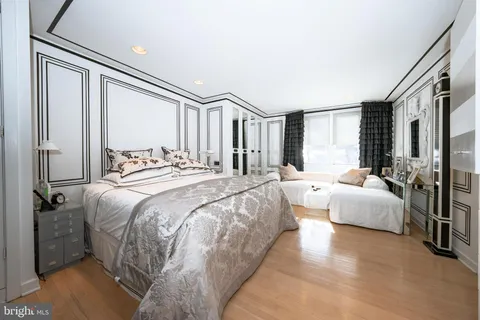a spacious bedroom with a bed and a large window