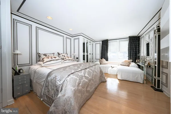 a spacious bedroom with a bed and a large window