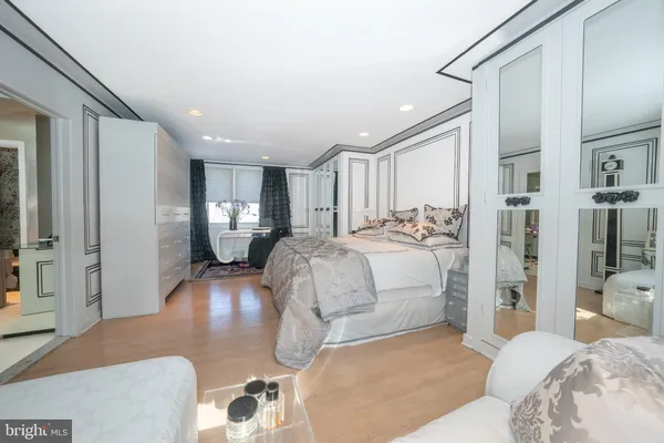 a bedroom with a large bed and a couch
