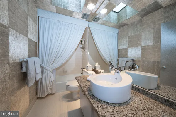 a bathroom with a bathtub and sink