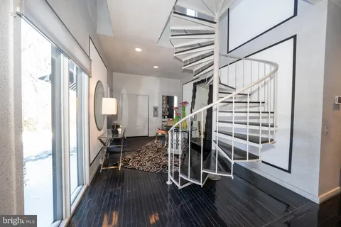 a view of entryway with wooden floor and stairs
