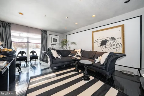 a living room with furniture a table and a large window