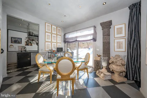 a dining room with furniture a chandelier and wooden floor