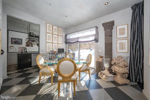 a dining room with furniture a chandelier and wooden floor