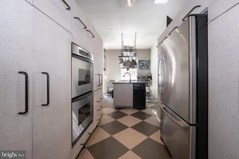 a kitchen with stainless steel appliances a refrigerator and cabinets