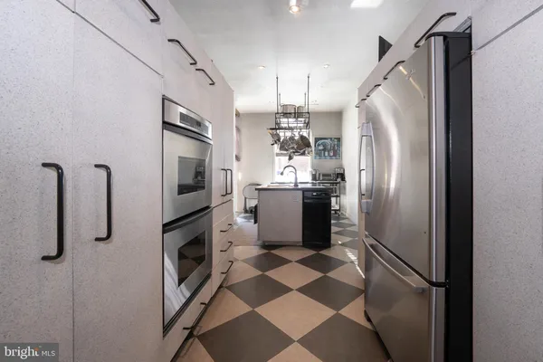 a kitchen with stainless steel appliances a refrigerator and cabinets