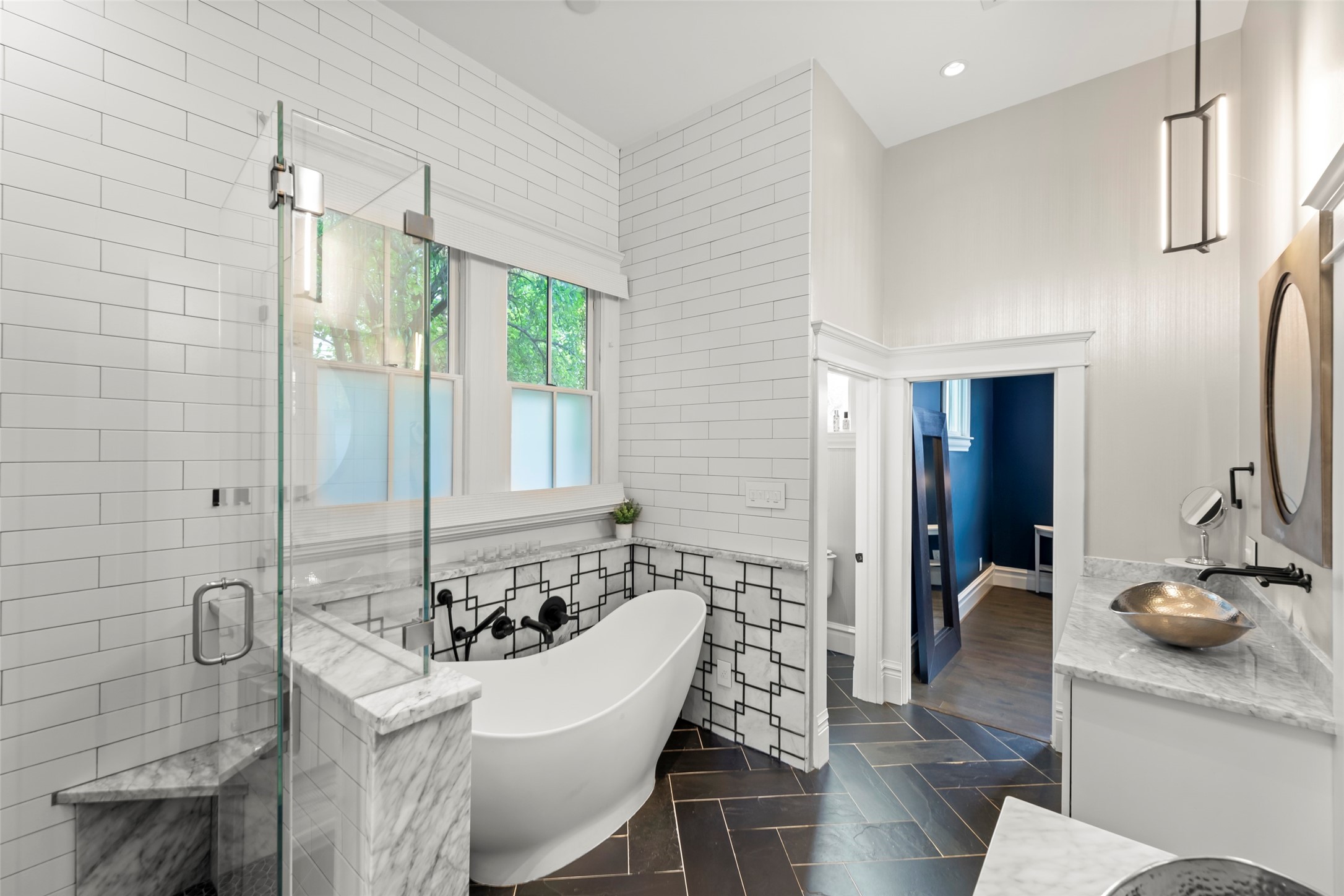 1810 Kane Street Houston, TX 77007 - Photo 26 of 47 a bathroom with a tub and a large mirror