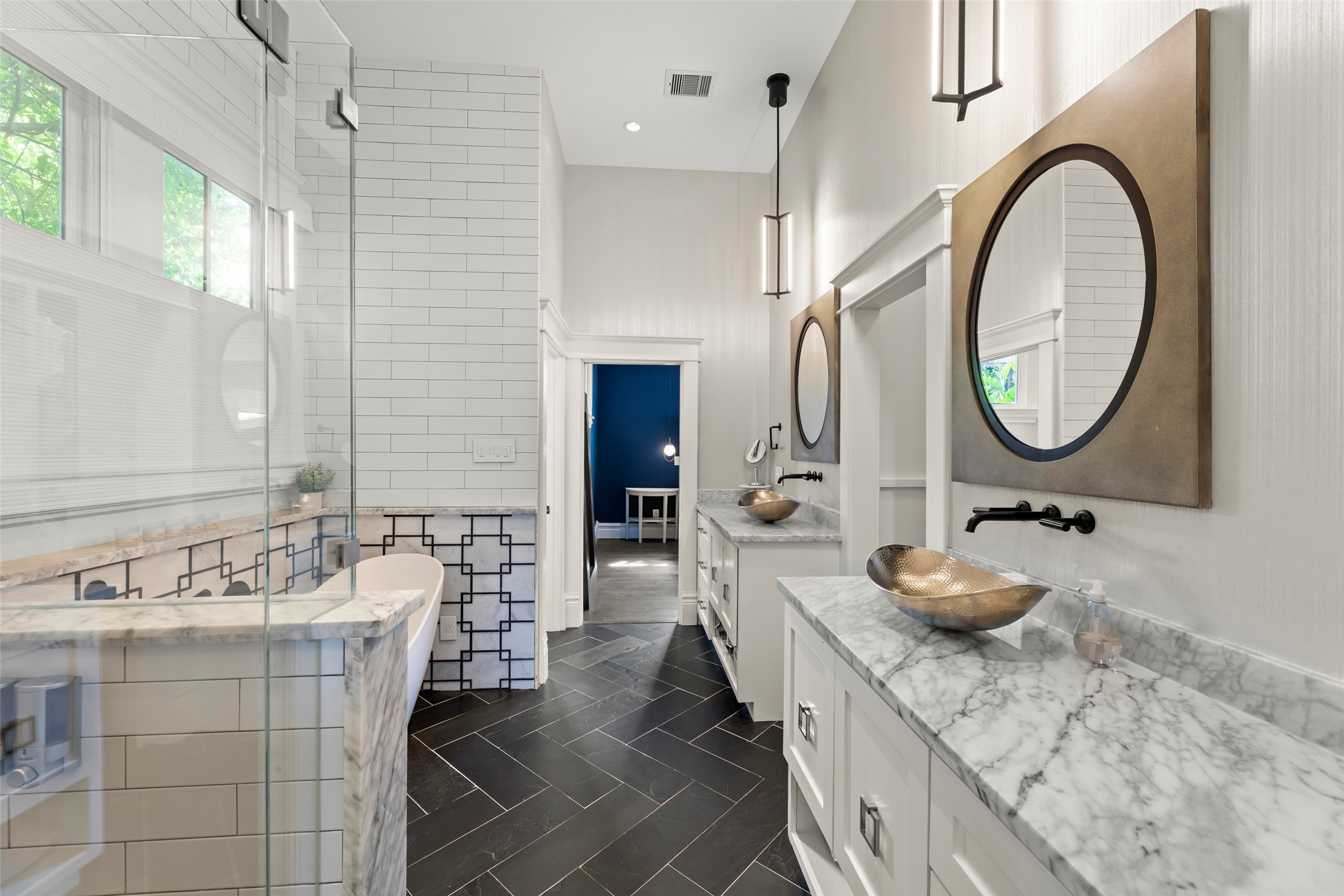 1810 Kane Street Houston, TX 77007 - Photo 28 of 47 a bathroom with a granite countertop sink a mirror and a wooden floors