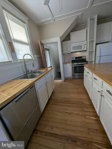 a kitchen with stainless steel appliances a sink stove and cabinets