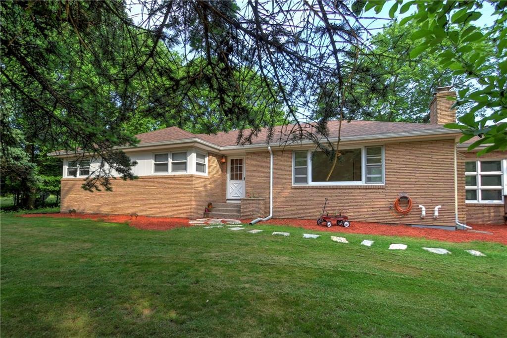 19 Grannis Road Orange, CT 06477 - Photo 1 of 1 a front view of a house with a yard and trees