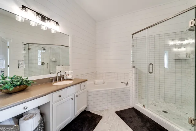 a spacious bathroom with a shower sink and mirror
