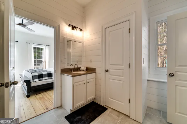 a kitchen with a sink and white cabinets