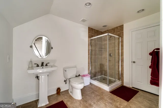 a bathroom with a toilet sink and shower