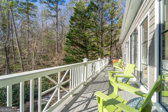 a view of balcony with wooden floor and outdoor seating