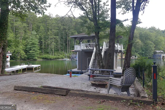 a view of a lake with a bench in the patio