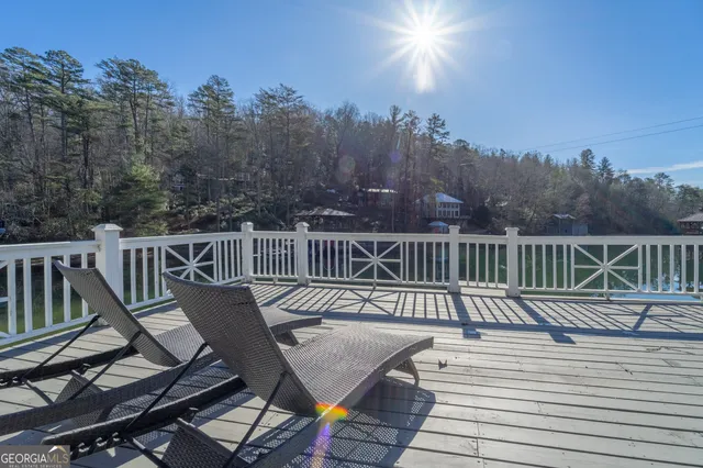 a view of a balcony with wooden floor and outdoor seating