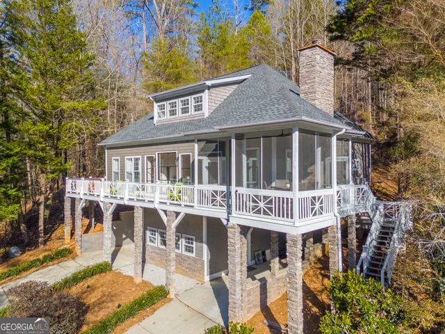 a view of a house with backyard porch and sitting area