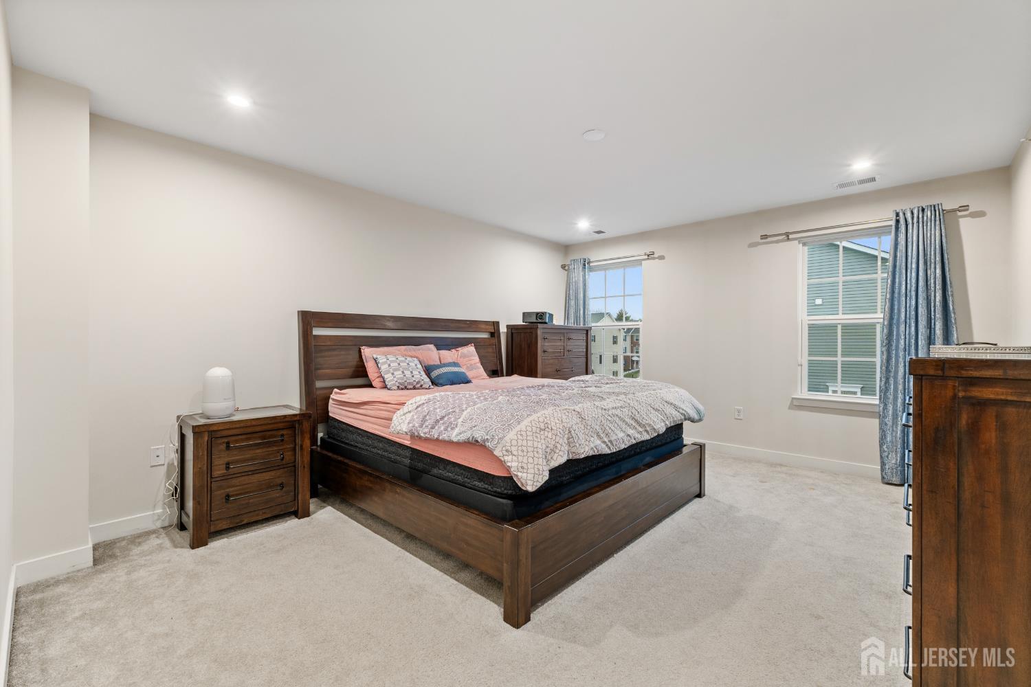 74 Anchor Way Cliffwood, NJ 07721 - Photo 16 of 35 a bed sitting in a spacious bedroom next to a window and a larger closet