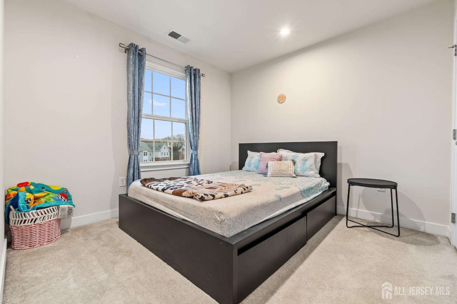 74 Anchor Way Cliffwood, NJ 07721 - Photo 21 of 35 a bedroom with a bed and a window