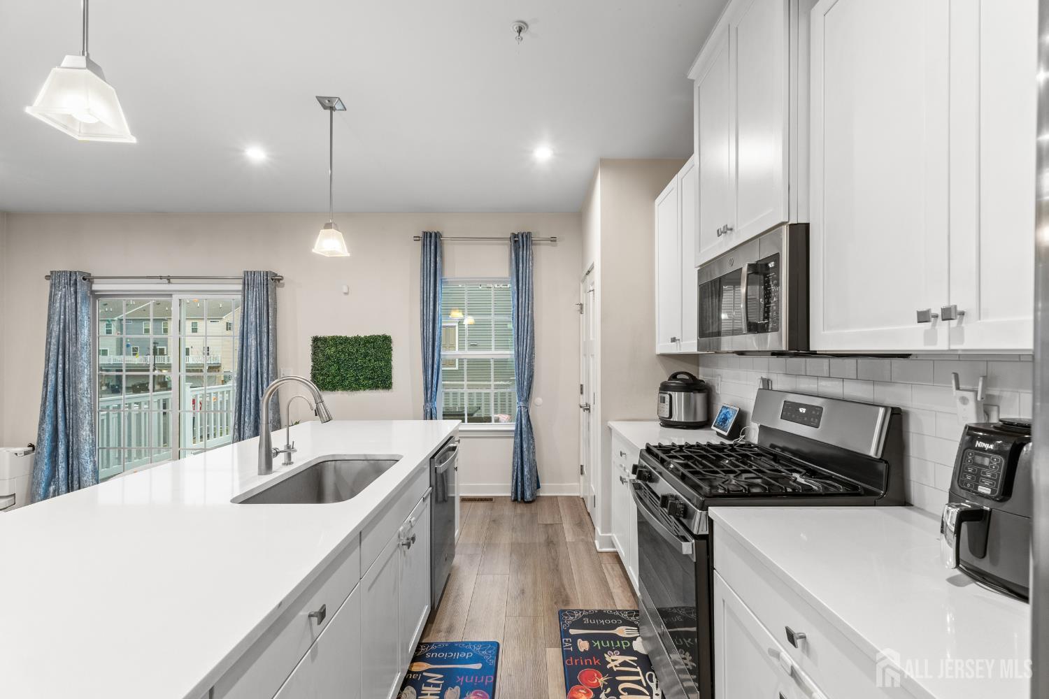 74 Anchor Way Cliffwood, NJ 07721 - Photo 10 of 35 a kitchen that has a sink and a stove in it