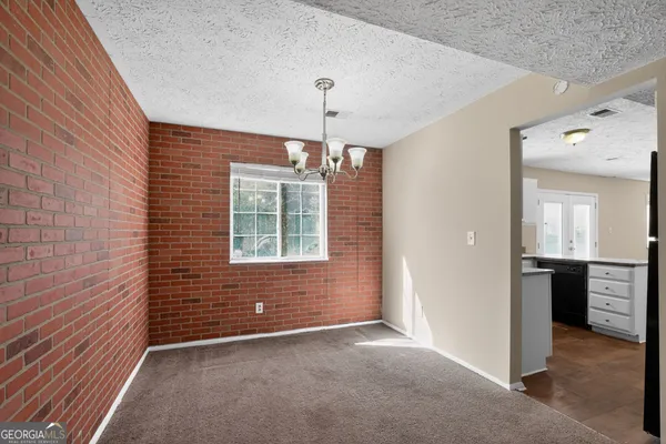 a view of an empty room with window and cabinet