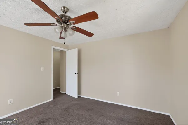 a view of a room with a ceiling fan